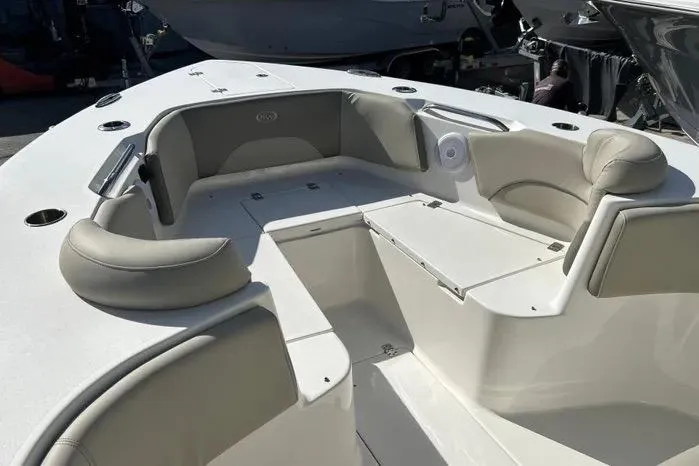 Slide: The Image of 2023 Key West 263 FS boat interior with cushioned seating and storage compartments. - 8