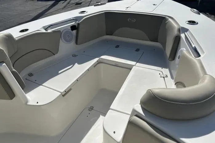Slide: The Image of 2023 Key West 263 FS boat interior with cushioned seating and storage compartments. - 9