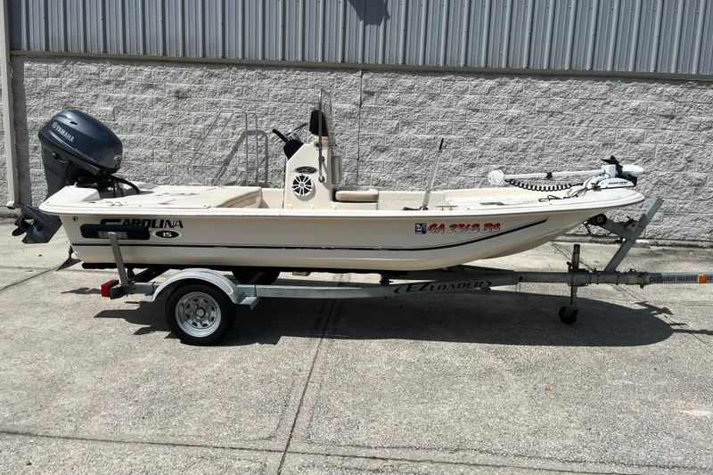 The Image of 2015 Carolina Skiff JV15CC boat on trailer, parked outdoors. - 1