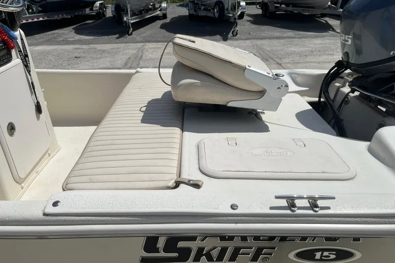 Slide: The Image of 2015 Carolina Skiff JV15CC boat interior with seating and storage compartments. - 10