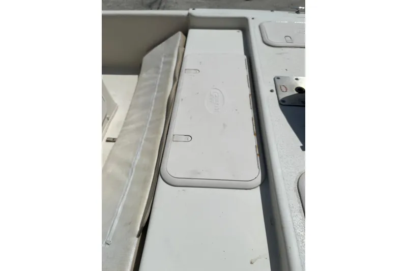 Slide: The Image of 2015 Carolina Skiff JV15CC boat deck with storage compartments and seating area. - 12