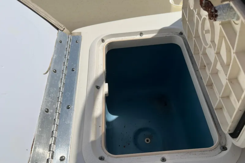 Slide: The Image of Open storage compartment on a 2015 Carolina Skiff JV15CC boat. - 18