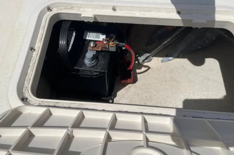 Slide: The Image of Battery compartment of a 2015 Carolina Skiff JV15CC boat, showing battery and anchor storage. - 22