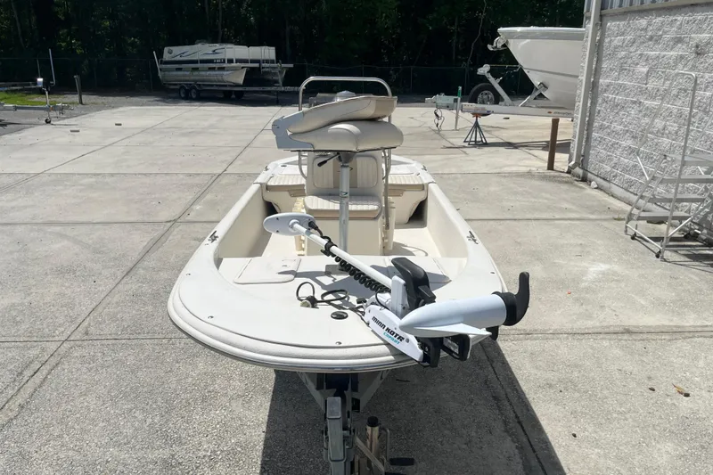 Slide: The Image of 2015 Carolina Skiff JV15CC boat with trolling motor, parked outdoors on concrete. - 6