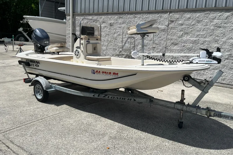 Slide: The Image of 2015 Carolina Skiff JV15CC boat on trailer, parked outdoors. - 7