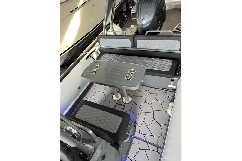 Slide: The Image of Interior of 2026 Highfield Sport 760 boat with seating and table setup. - 10