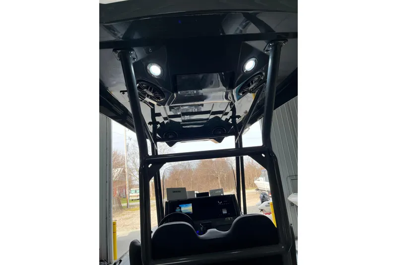 Slide: The Image of Interior view of 2026 Highfield Sport 760 boat, showcasing modern dashboard and overhead lighting. - 13