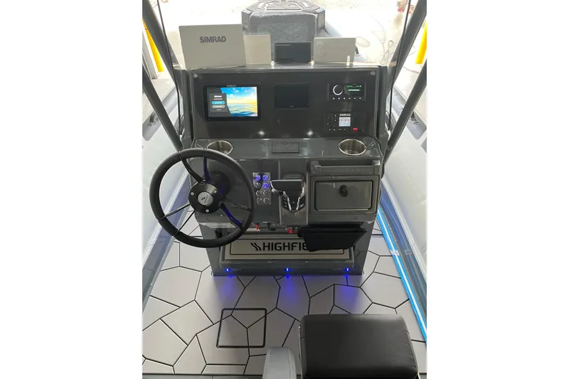 Slide: The Image of 2026 Highfield Sport 760 boat dashboard with steering wheel, Simrad display, and modern controls. - 7