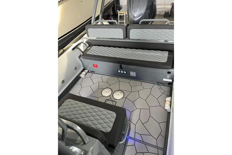 Slide: The Image of Interior of 2026 Highfield Sport 760 boat with modern seating and geometric flooring design. - 9