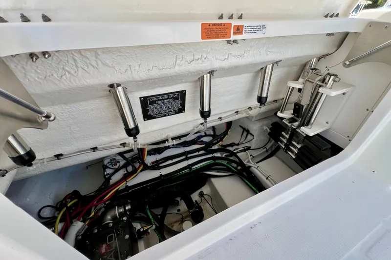 Slide: The Image of 2026 Robalo R300 Center Console boat engine compartment with wiring and hydraulic systems. - 14