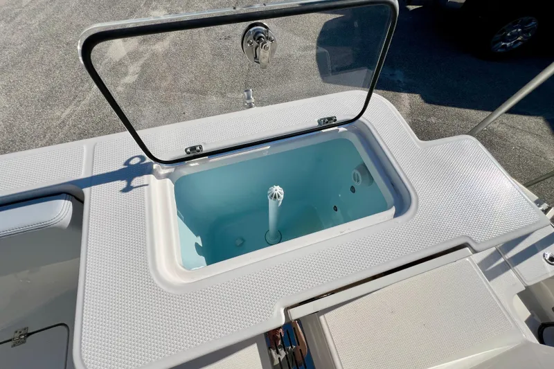 Slide: The Image of Livewell on 2026 Robalo R300 Center Console boat, open lid, textured surface. - 15
