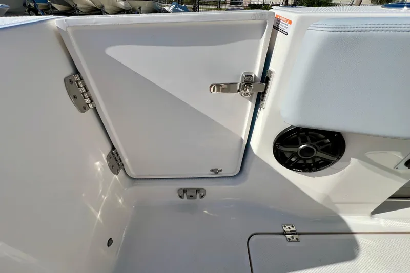 Slide: The Image of 2026 Robalo R300 Center Console boat interior with storage compartment and speaker. - 18