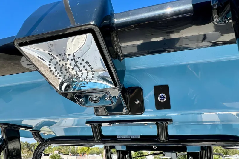 Slide: The Image of 2026 Robalo R300 Center Console boat with sleek blue finish and modern lighting. - 20