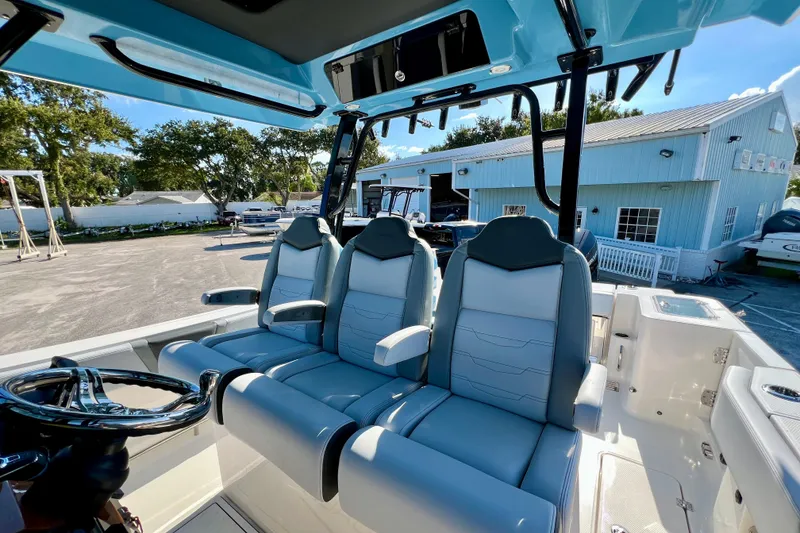 Slide: The Image of 2026 Robalo R300 Center Console boat interior with three cushioned seats. - 30
