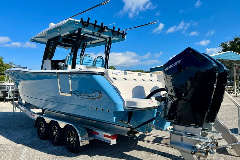Slide: The Image of 2026 Robalo R300 Center Console boat with Mercury engines on a trailer. - 35