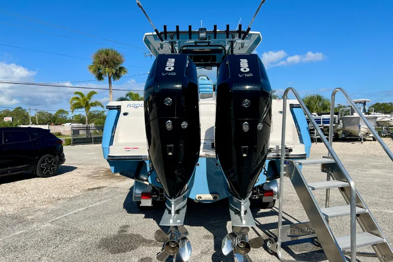 Slide: The Image of 2026 Robalo R300 Center Console boat with twin outboard engines, parked outdoors. - 36