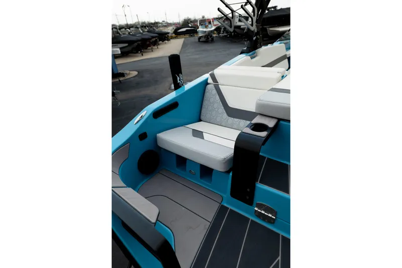 Slide: The Image of 2023 Heyday H22 boat interior with blue and gray seating, cup holder, and modern design. - 15