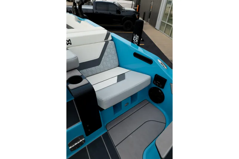 Slide: The Image of 2023 Heyday H22 boat interior with blue and gray seating, cup holder, and speaker. - 16