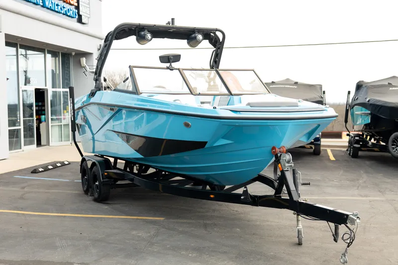 Slide: The Image of 2023 Heyday H22 boat in vibrant blue on a trailer outside a dealership. - 9