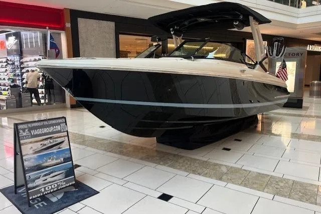 Slide: The Image of 2026 Chris-Craft Sportster 25 boat displayed indoors, showcasing sleek design and luxury features. - 1