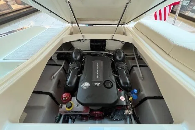 Slide: The Image of 2026 Chris-Craft Sportster 25 engine compartment with open hatch, showcasing powerful motor design. - 13