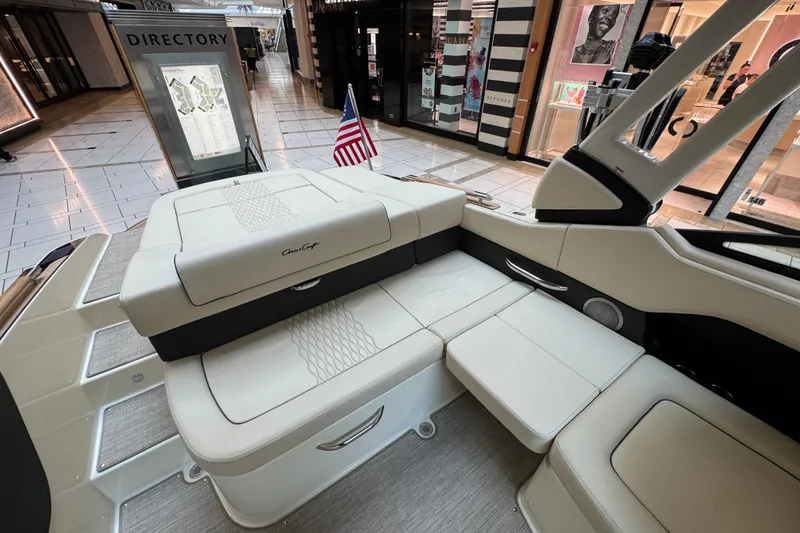 Slide: The Image of 2026 Chris-Craft Sportster 25 boat interior displayed in a shopping mall setting. - 15