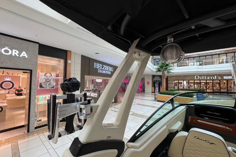 Slide: The Image of 2026 Chris-Craft Sportster 25 boat displayed in a shopping mall near retail stores. - 17