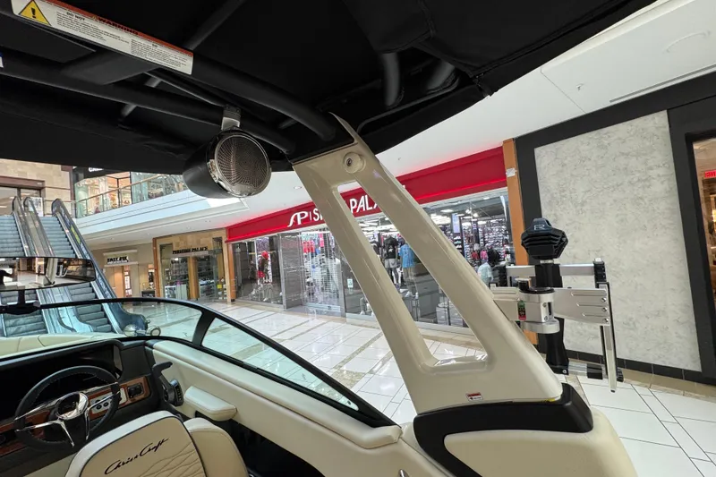 Slide: The Image of Interior view of 2026 Chris-Craft Sportster 25 boat displayed in a shopping mall. - 18