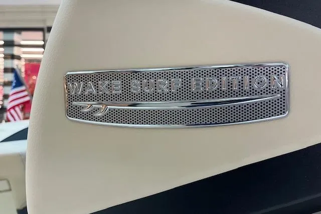 Slide: The Image of 2026 Chris-Craft Sportster 25 Wake Surf Edition badge on beige interior. - 19