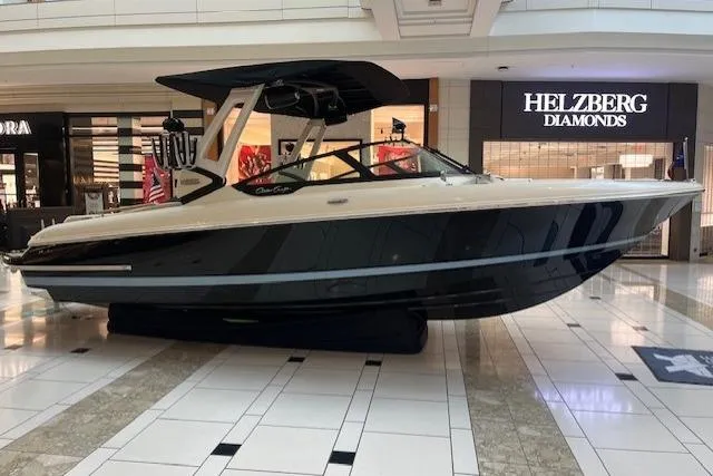 Slide: The Image of 2026 Chris-Craft Sportster 25 boat displayed in a shopping mall near Helzberg Diamonds. - 2