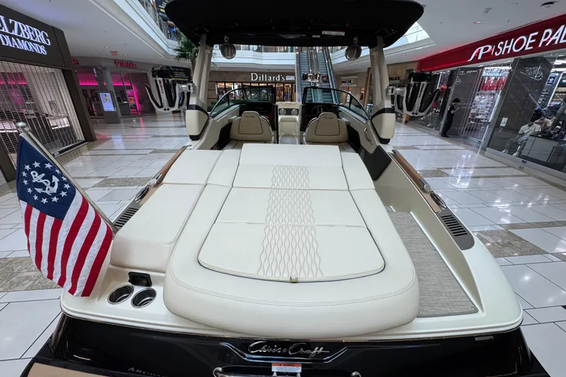 Slide: The Image of 2026 Chris-Craft Sportster 25 boat displayed in a shopping mall, featuring luxurious seating and American flag. - 20