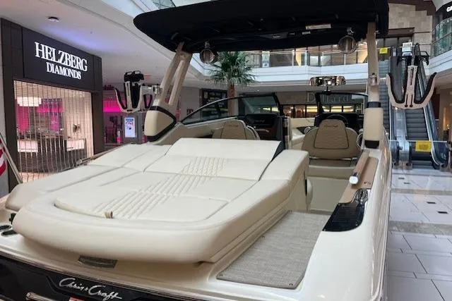 Slide: The Image of 2026 Chris-Craft Sportster 25 luxury boat displayed in a shopping mall setting. - 4