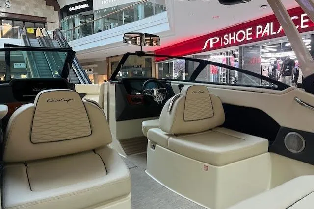 Slide: The Image of Interior of 2026 Chris-Craft Sportster 25 boat displayed in a shopping mall. - 5