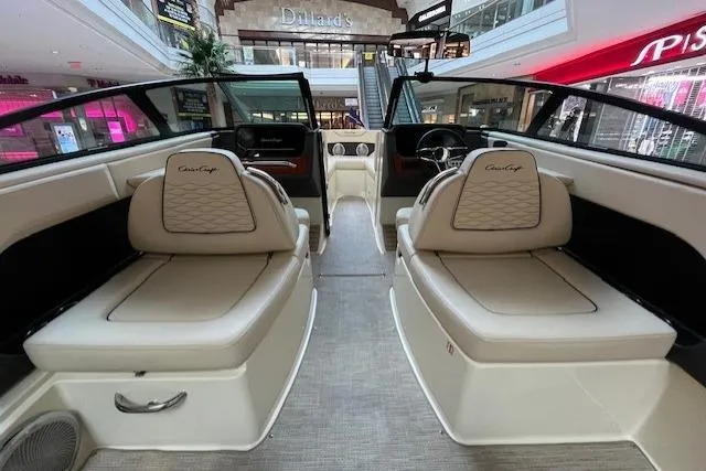 Slide: The Image of 2026 Chris-Craft Sportster 25 interior with luxurious seating in a shopping mall display. - 9