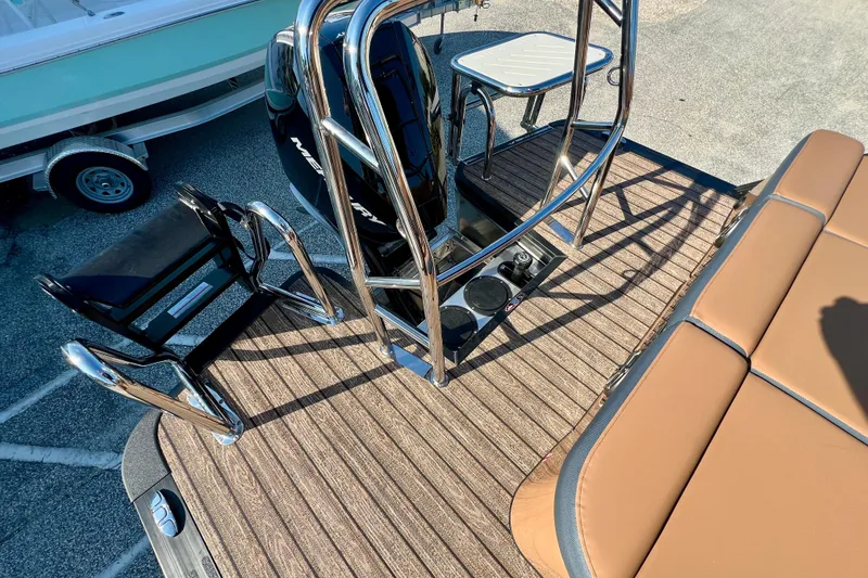 Slide: The Image of 2026 Harris Grand Mariner 230 boat deck with seating and motor. - 17