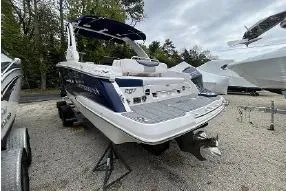 Slide: The Image of 2021 Chaparral 267 SSX boat displayed outdoors on gravel lot. - 1