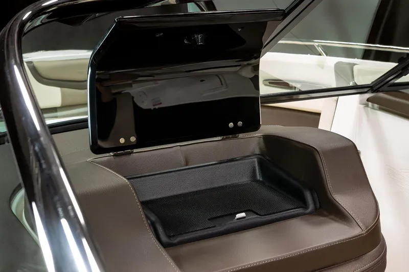Slide: The Image of Manufacturer Provided Image: 2021 Chaparral 267 SSX boat storage compartment with open lid. - 10