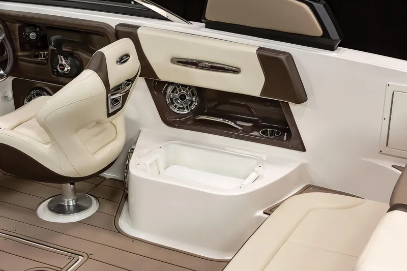 Slide: The Image of Manufacturer Provided Image: Interior of 2021 Chaparral 267 SSX boat with beige seating and storage compartment. - 12