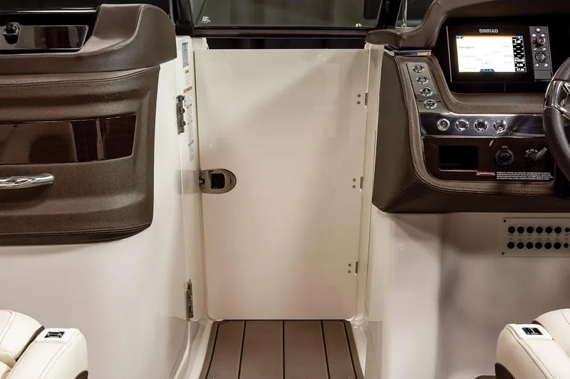 Slide: The Image of Manufacturer Provided Image: 2021 Chaparral 267 SSX boat interior with dashboard and cabin door. - 6
