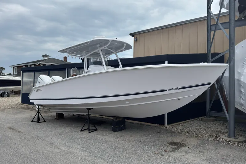 Slide: The Image of 2026 Jupiter 30 boat on display, white hull, outdoor setting, overcast sky. - 1