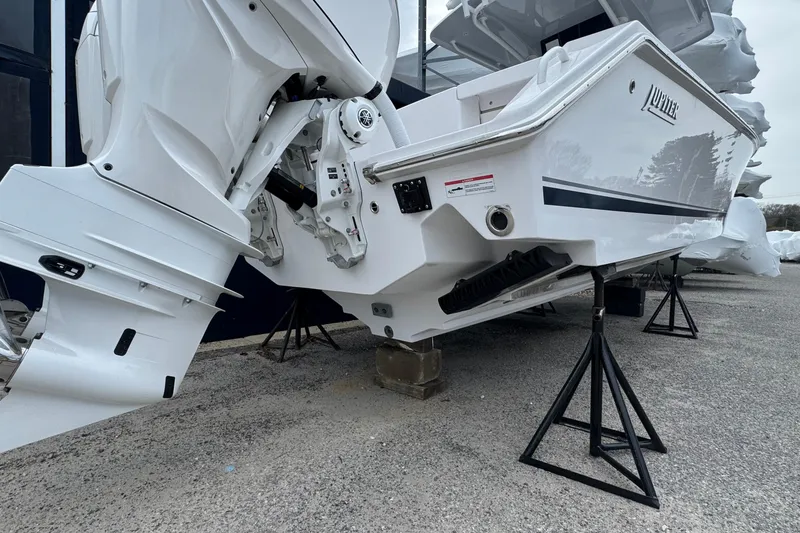 Slide: The Image of 2026 Jupiter 30 boat on stands, showcasing sleek design and powerful outboard motor. - 10