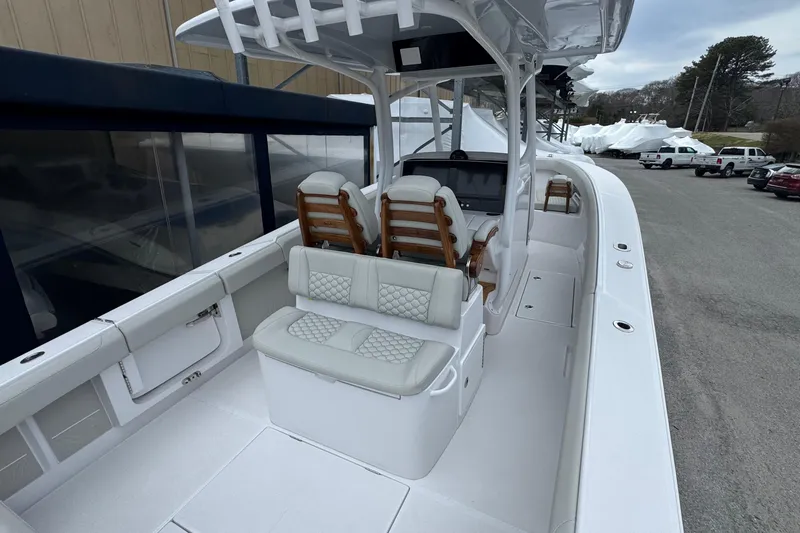 Slide: The Image of 2026 Jupiter 30 boat interior with cushioned seating and modern helm station. - 11