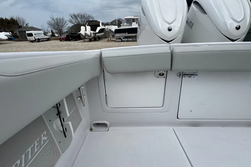 Slide: The Image of Interior view of a 2026 Jupiter 30 boat, showcasing seating and storage compartments. - 13