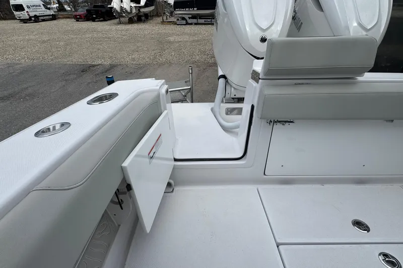 Slide: The Image of 2026 Jupiter 30 boat interior with open storage compartment and sleek seating. - 14