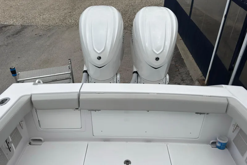 Slide: The Image of 2026 Jupiter 30 boat with dual outboard engines, viewed from the rear deck. - 16