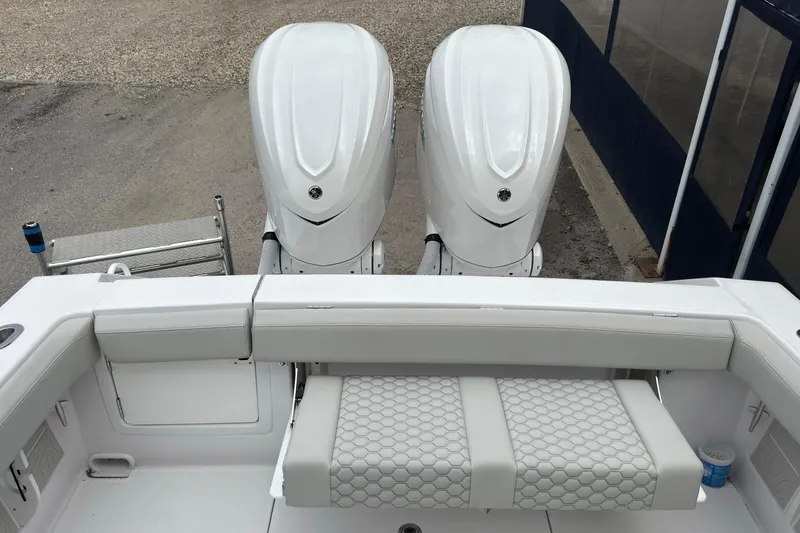 Slide: The Image of 2026 Jupiter 30 boat with dual outboard engines and cushioned seating. - 18