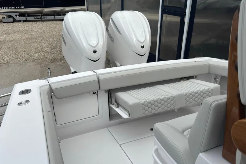 Slide: The Image of Interior of a 2026 Jupiter 30 boat with dual outboard engines and cushioned seating. - 20