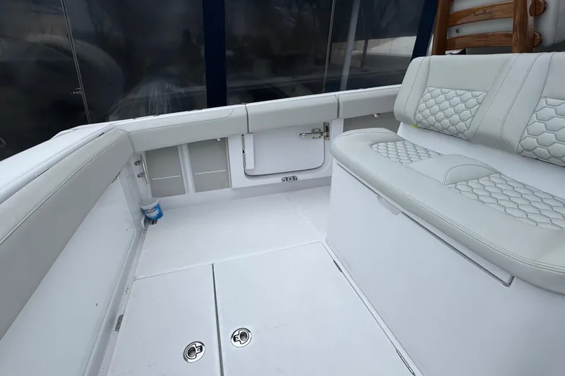 Slide: The Image of Luxurious seating area on a 2026 Jupiter 30 boat with white upholstery. - 21