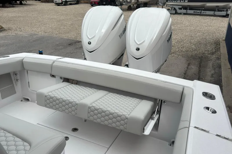 Slide: The Image of 2026 Jupiter 30 boat interior with dual outboard engines and cushioned seating. - 22