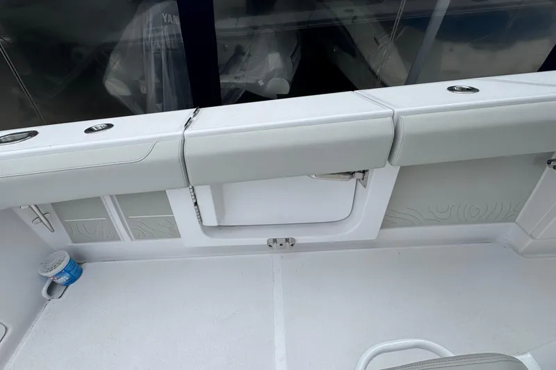 Slide: The Image of Interior view of a 2026 Jupiter 30 boat, featuring sleek seating and storage compartments. - 23